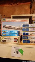 Photo showing stacked model kits including Revell Lockheed Super Constellation, Mini 1:144 Hawker Tempest Mk.V, Hawker Typhoon Mk.1B, and Airfix Monty's Humber 1:32 scale model.