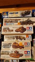Stack of six model kit boxes: Italeri WC56 Staff Car, Tamiya SdKfz 232, King Tiger, Desert Group Chevrolet Truck, SdKfz 250/3, Matilda
