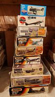 Stack of nine 1:72 scale plastic aircraft model kits from brands Airfix, Matchbox, Novo. Boxes are colorful, showing illustrations of airplane models, various WWII and military aircraft.