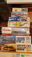 Stacked view of all seven boxed kits showing top of lot