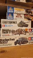 Stack of five model kits boxes clearly showing names and scale: Chevrolet 15-CWT, Tank M13/40, Chieftain Mk5, 88mm Gun Flak 36/37, and 8 ton Semi Track Sd.Kfz7