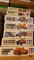 Stack of six Tamiya 1:35 scale military model kits in original boxes showing titles and box artwork.