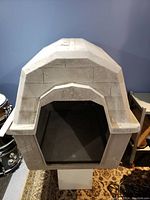 Full view of plastic pet house with textured walls and arched entrance for small animals