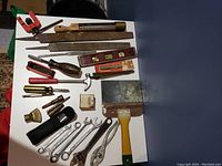 Overview of assorted hand tools including files, levels, wrenches, hammers, screwdrivers, and Bosch tool bag.