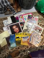 23 vinyl records spread out on a rug, including albums by Melissa Manchester, Elton John, Men at Work, Funny Lady and others.