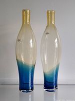 Pair of tall Blenko art glass vases with amber to blue fade gradient, with labels visible