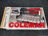 Box showing Coleman two burner propane stove label and product image.