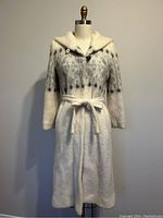 Front view of long wool coat on dress form, showing overall design and length.