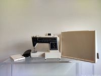 Full view of Singer 560 Diana sewing machine alongside foot pedal and carrying case, showing machine on a clear surface.