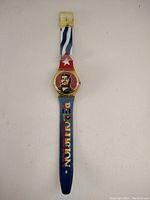 Full view of vintage Che Guevara Swatch wristwatch showing strap design and watch face with portrait of Che Guevara.