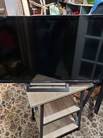 Full front view of the Sony 32 inch flat screen TV on a stand.