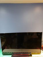 Front view of the 46 inch Sony flat-screen television with black frame and screen off reflecting surroundings.