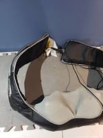 Back massager laid flat with visible adjustable straps and power cord