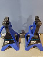 Pair of blue Certified 2-tonne axle stands showing front and side profiles