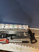 Various measuring tools including calipers, metal ruler and boxed item with Chinese text.