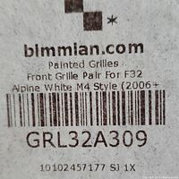 Close-up image of label on product box showing bimmian.com, product code GRL32A309, and details for front grille pair for BMW F32 Alpine White M4 Style 2006+