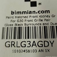 Close-up of bimmian.com label detailing product as paint matched front kidney grille for G30, gloss black surrounds, barcode and product code GRLG3AGDY