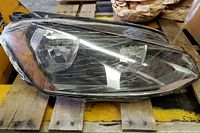 LED headlight with clear lens, showing shrink wrap protection.