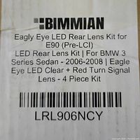 Label showing product details: Bimmian Eagle Eye LED Rear Lens Kit for BMW 3 Series Sedan E90 (2006-2008), clear and red turn signal lenses, 4 piece kit.