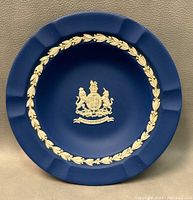 Top view photo of the royal blue fluted jasperware candy dish with a central gold royal crest emblem.