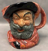 Front view of the Toby mug with detailed facial expression, black hat, and reddish-brown attire.