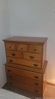 Front view of two-piece cherry tallboy dresser showing overall condition and hardware