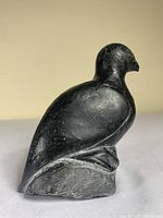 Photo of carved soapstone bird sculpture front profile showing bird shape and base.