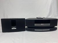 Overview of Bose SoundTouch on left and stacked Bose Wave system with CD changer on right, remote atop
