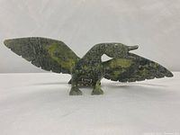 Front view of soapstone bird carving with wings fully extended