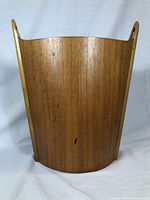 Full front view of teak waste paper bin on white backdrop