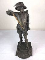 Front view of the vintage bronze-like spelter figure of Don Juan, showing detail of clothing and pose