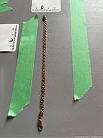 full view of 7 inch gold chain bracelet laid flat on surface