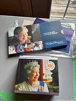 Book-style packaging of the Royal Portrait Collection with images of Queen Elizabeth II in formal attire on the cover
