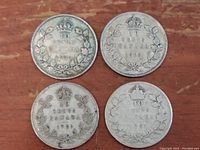 Reverse side showing denomination '10 CENTS CANADA' with crown above and maple leaf wreath with dates 1920 (2 coins) and 1931 (2 coins).