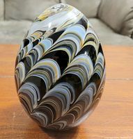Front view of large glass decorative egg showing multicolor swirling pattern