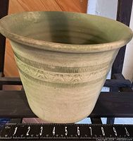 Side profile photo showing the planter's flared top, decorative banding, and matte finish.