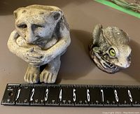 Concrete ogre and frog garden statues displayed with ruler showing size approx 5-6 inches