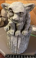 Front view of the gargoyle/ogre sculpture showing detailed face, hands, feet, and tree stump base with scale in inches.