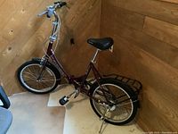 Side-angle view of full bike showing frame, wheels, handlebars, saddle, and rack