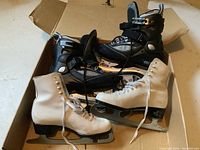 Pair of black women's ABEC 5 in-line skates and white SLM Canada figure ice skates side by side on floor
