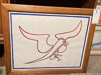 Full frontal image of framed bird of prey artwork featuring bold red and brown lines with yellow accents, signed and dated 'Anita Meyerink 82'. Framed in wood with glass.