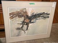 Framed limited edition print showing bird with outstretched wings and neutral tones, within a beige mat and a wide glass frame.