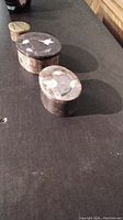 Photo of three soapstone trinket boxes arranged in a line showing their sizes and lid designs featuring Abalone and brass inlay.