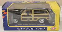 Photo of 1:24 scale die cast replica 1949 Ford Woody Wagon in inventory box, side view