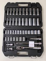 Open case showing both top and bottom trays filled with a variety of sockets, ratchets, extension bars and universal joint.