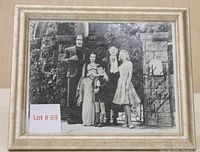 Full image of the framed black and white photo showing The Munsters cast with autograph and Lot number card