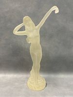 Front and side views of translucent frosted lucite figurine depicting standing woman with one arm raised, approx 11 inches tall.
