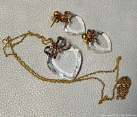 Overall photo of gold filled chain necklace and matching crystal heart earrings and pendant