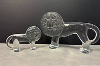 Photo of both glass lion figurines showing relative size and design details