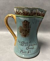 Side view showing the clock of Old St Dunstan's Church design and partial text on the jug
